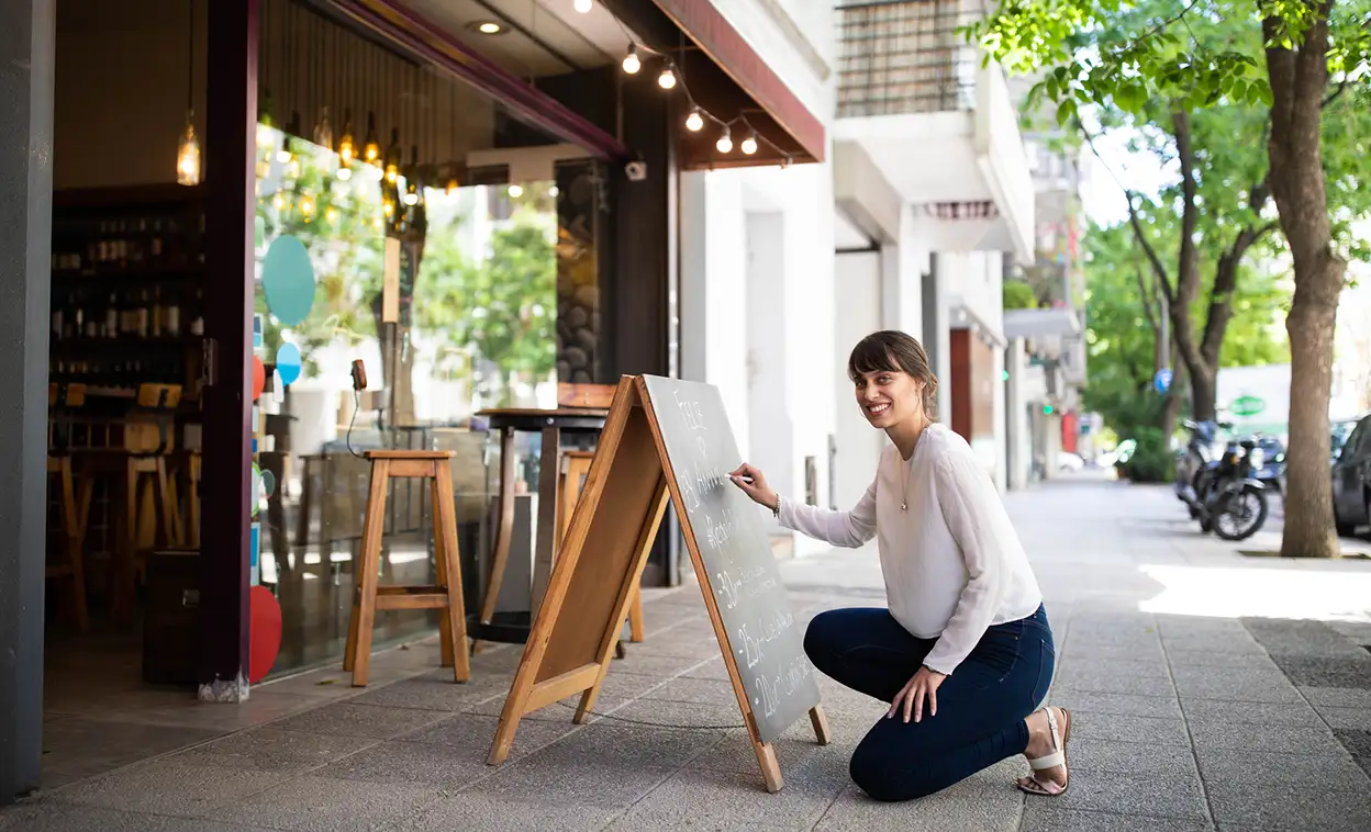 business woman writing on chalk board