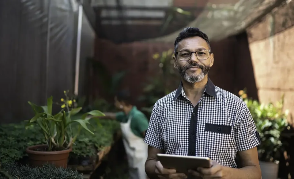 Man working in garden greenhouse