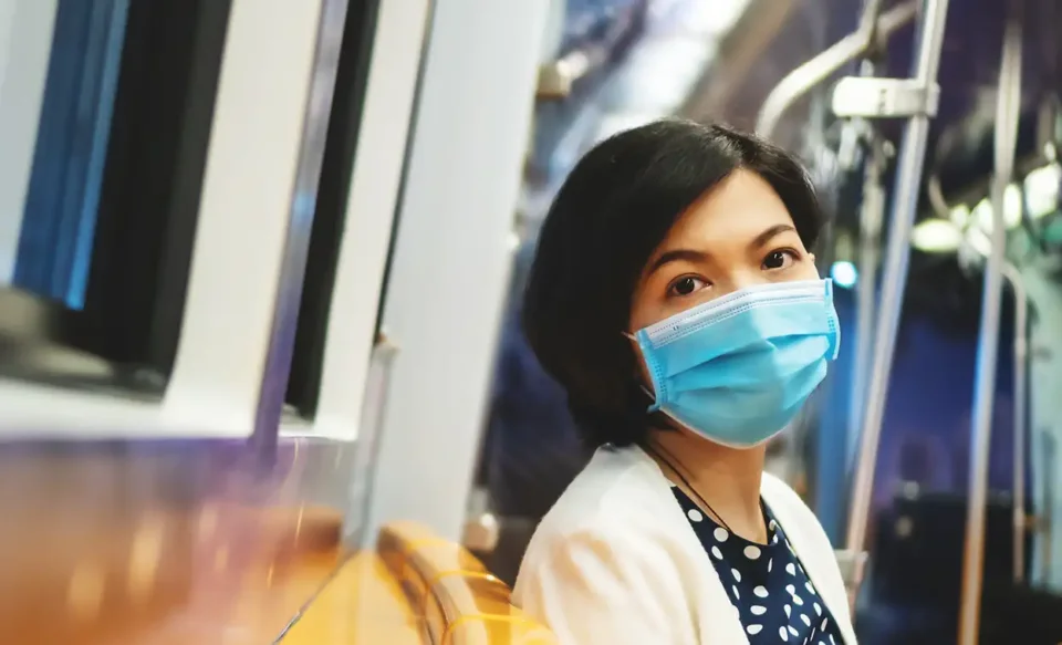 Woman wearing covid mask on subway