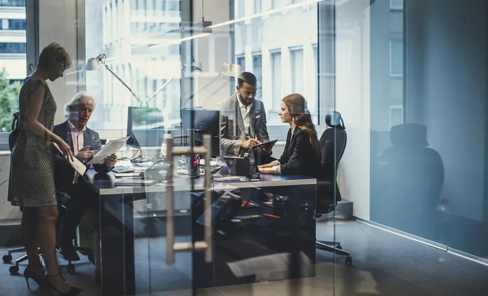 Office meeting behind glass wall