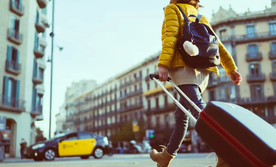 Woman with suitcase on her way to short term rental