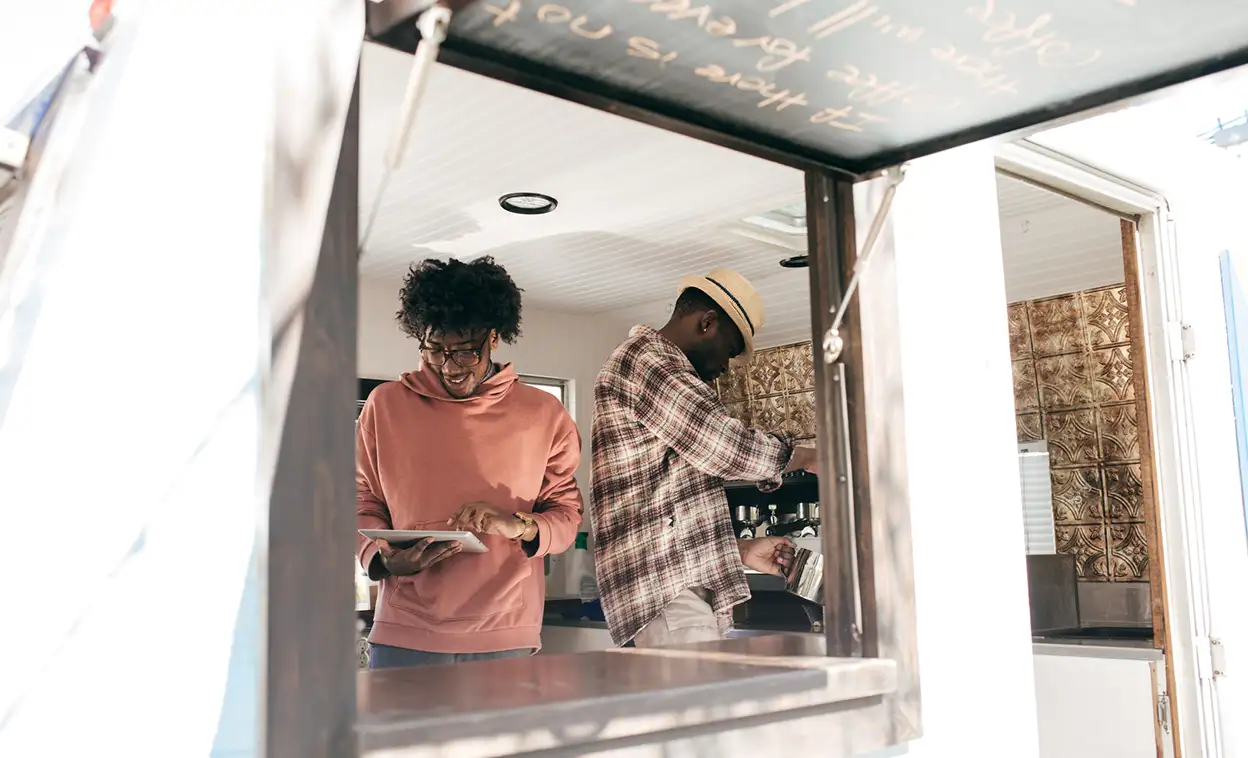 Two men inside a food truck