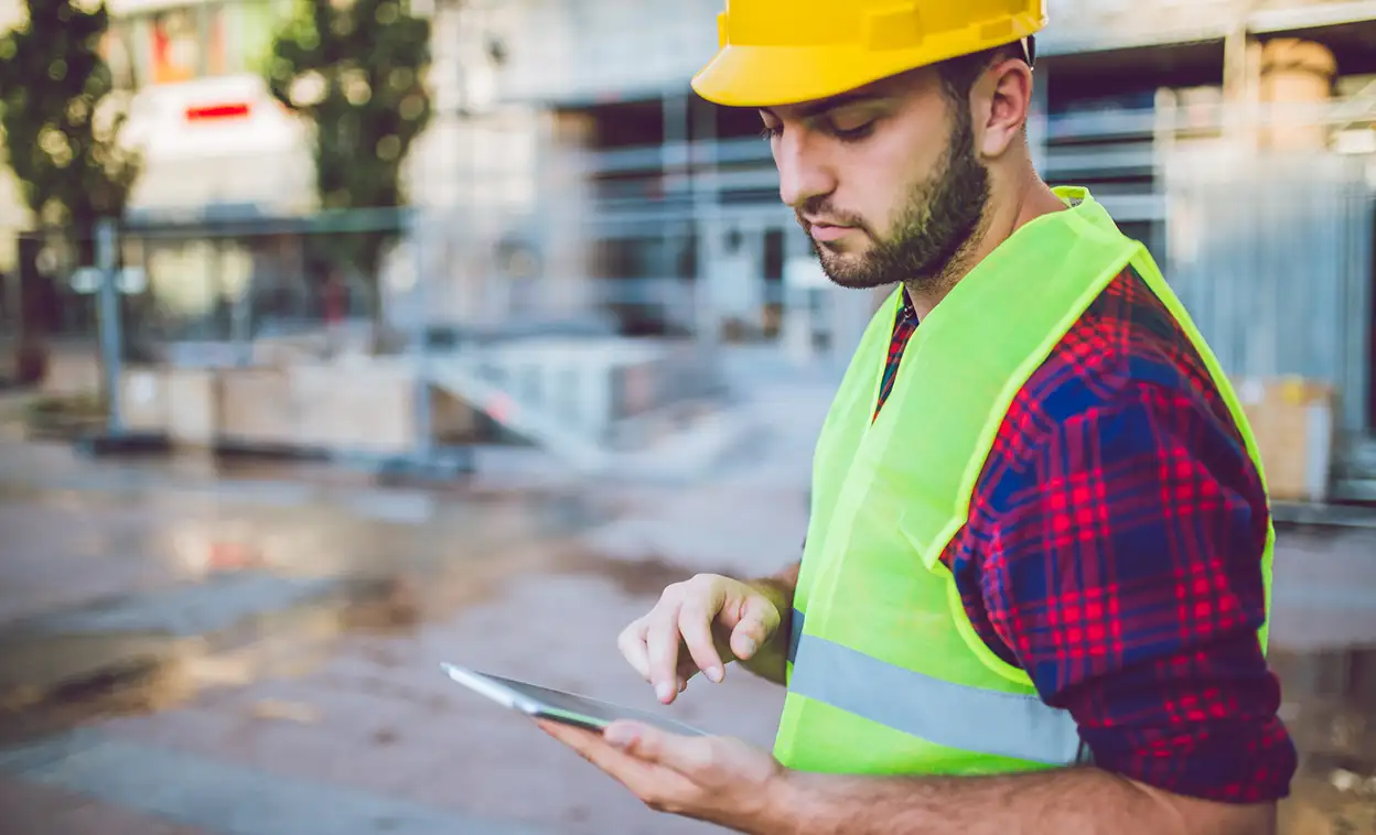 A construction worker on a tablet