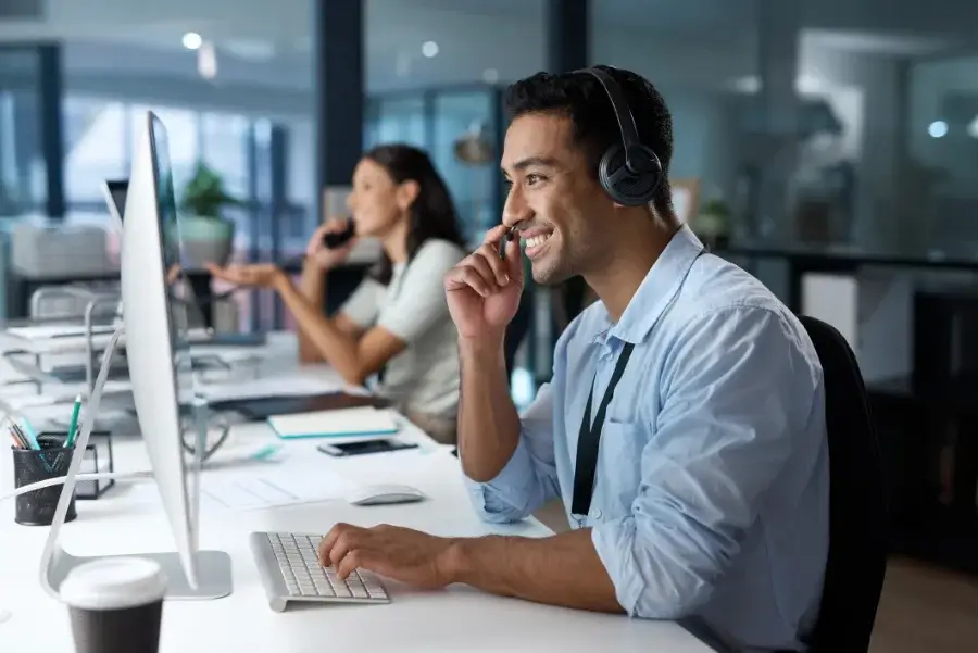 man working tech support in front of computer